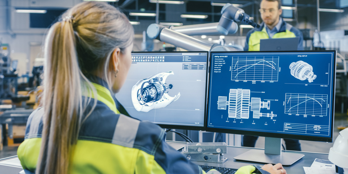 An engineer working on a design on two screens